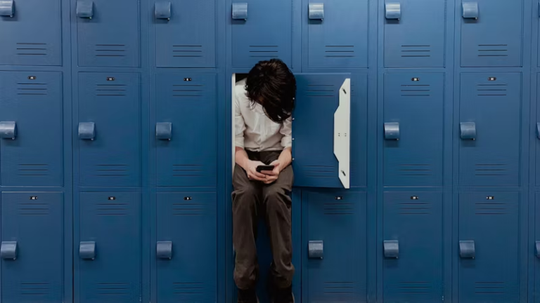 A girl sitting on a locker